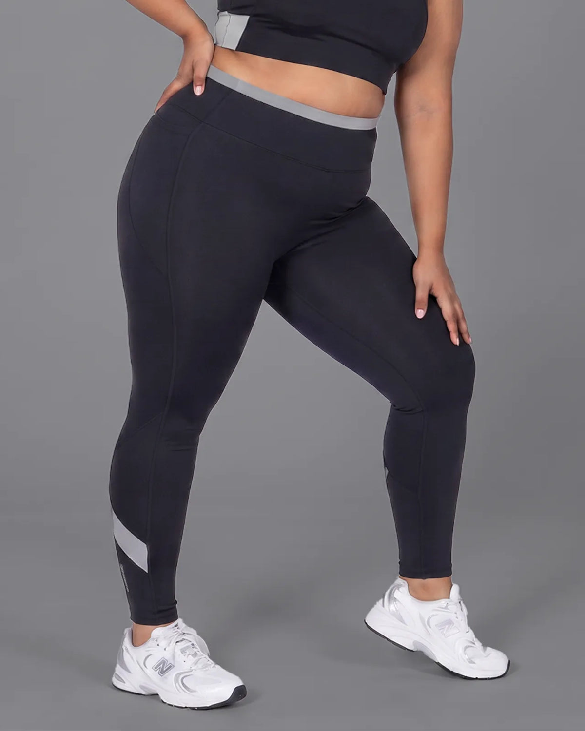 Front view of Black High-Rise Leggings with no front seam, a grey waistband and calf panels.