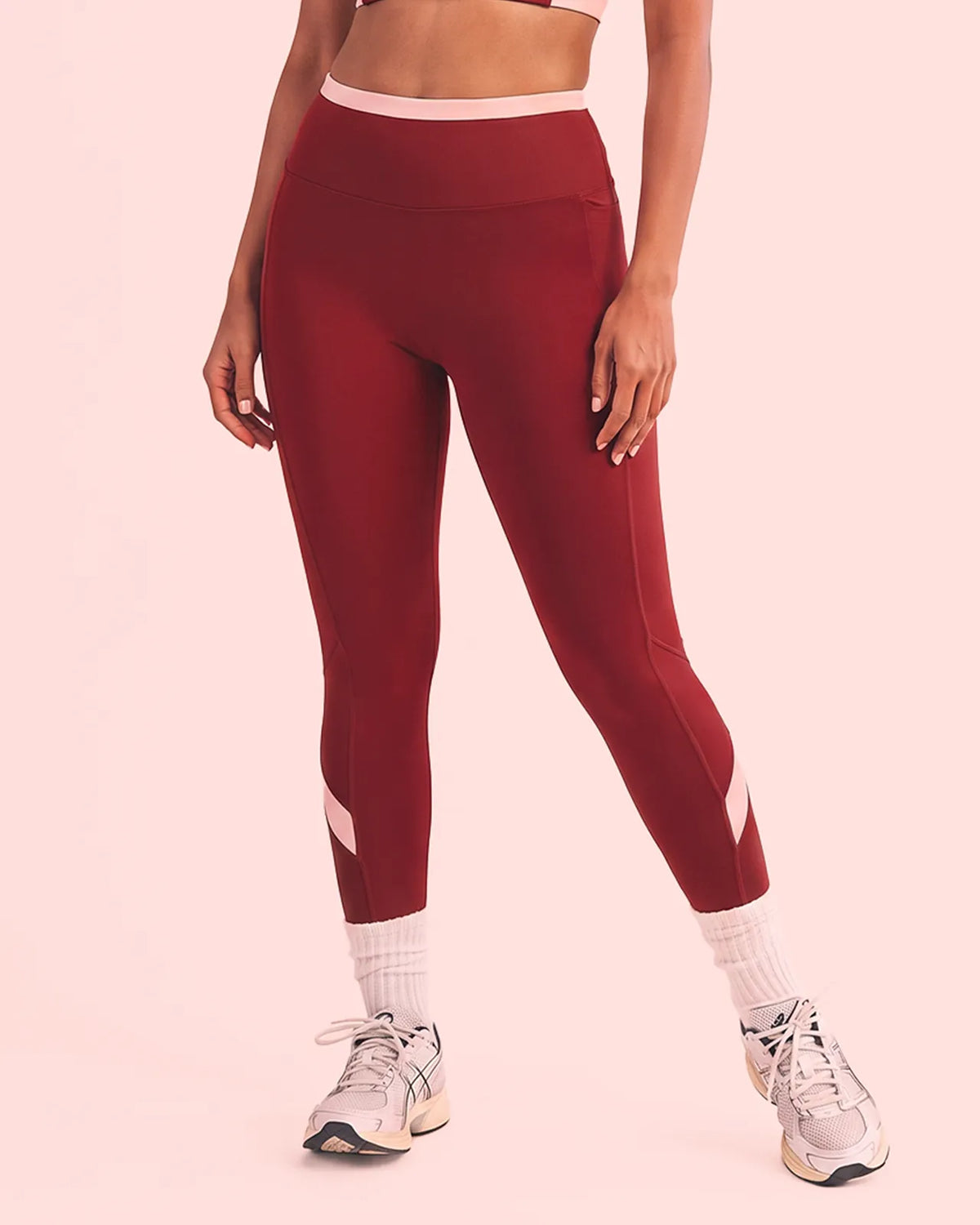 Front view of Maroon High-Rise Leggings with a smooth front, blush pink waistband and calf panels.