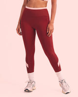 Front view of Maroon High-Rise Leggings with a smooth front, blush pink waistband and calf panels.