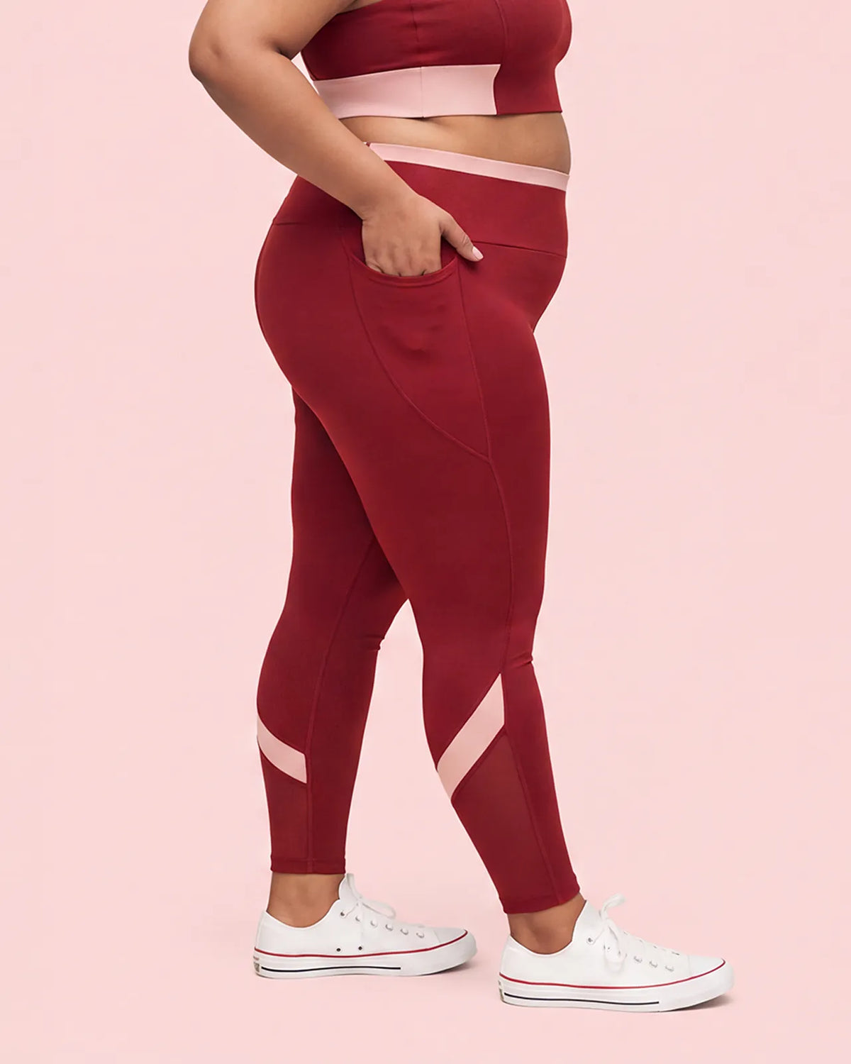 Side view of Maroon High-Rise Leggings with a hand tucked into the deep side pocket.