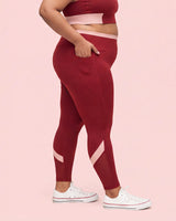 Side view of Maroon High-Rise Leggings with a hand tucked into the deep side pocket.