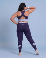 Full-length back view of the Navy sports bra and leggings, showing the racerback construction, keyhole opening and fit through the hips.