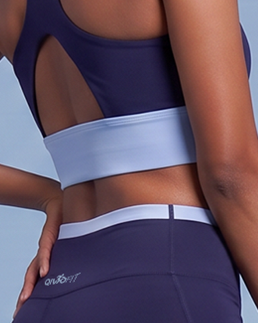 Close-up of the wide light blue underband on the navy sports bra, sitting flat across the back.