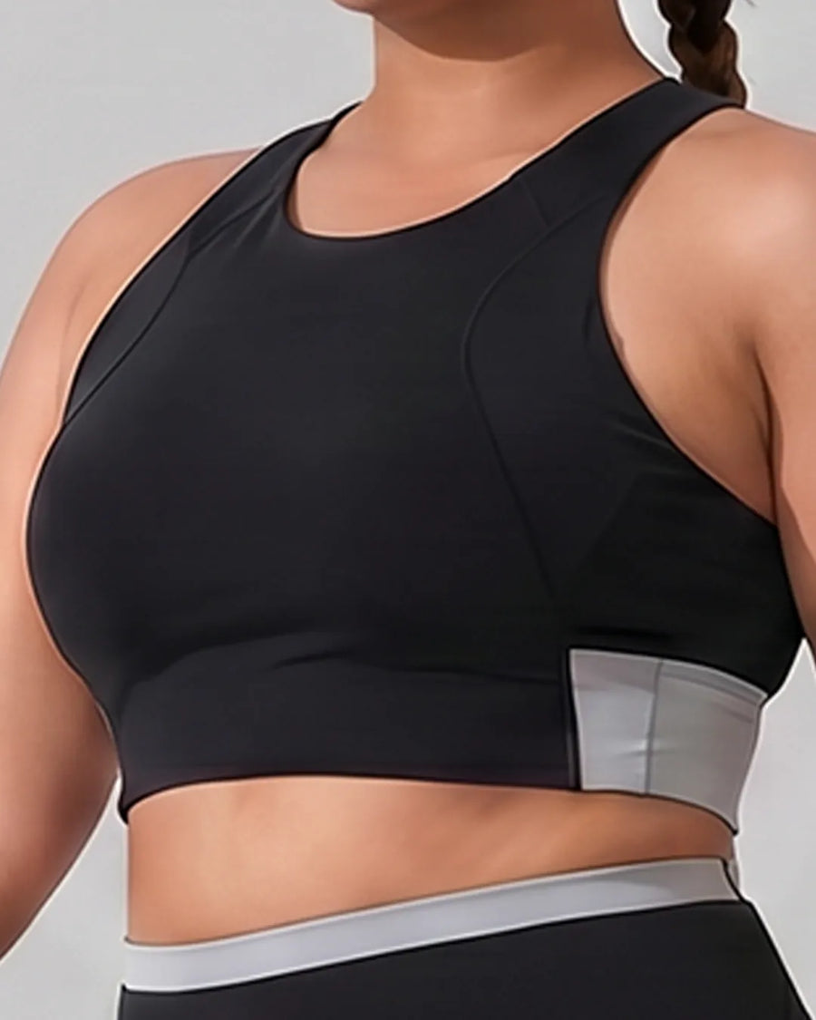 Front close-up of a black QivoFit sports bra with a high neckline, curved seams and a grey side panel